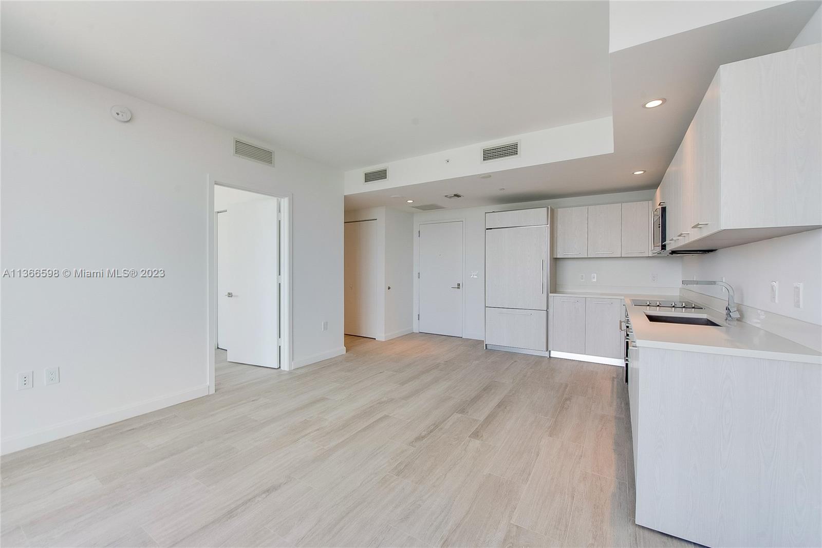 55 Southwest 9th Street, Unit 3607 Miami, FL 33130 - Photo 6 of 22 a view of empty room with wooden floor