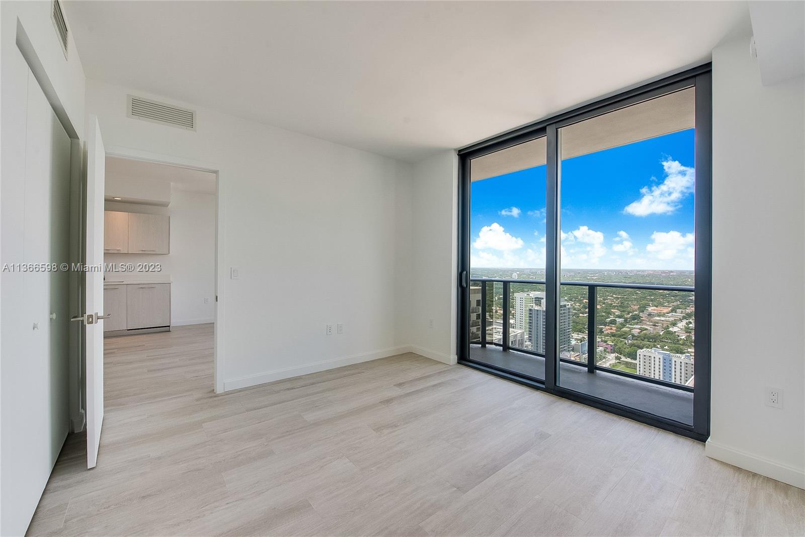 55 Southwest 9th Street, Unit 3607 Miami, FL 33130 - Photo 7 of 22 wooden floor in an empty room with a window