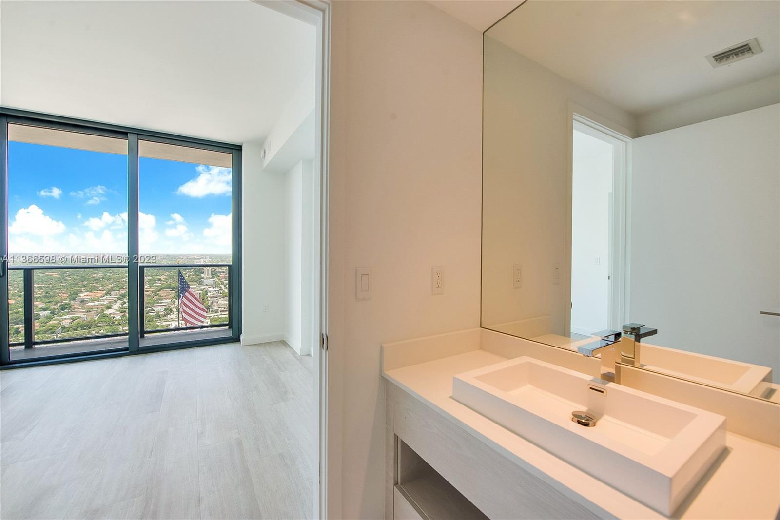 55 Southwest 9th Street, Unit 3607 Miami, FL 33130 - Photo 8 of 22 a bathroom with a sink and a large mirror
