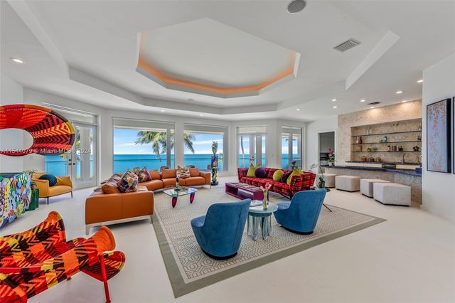 a kitchen with stainless steel appliances kitchen island granite countertop a sink and white cabinets