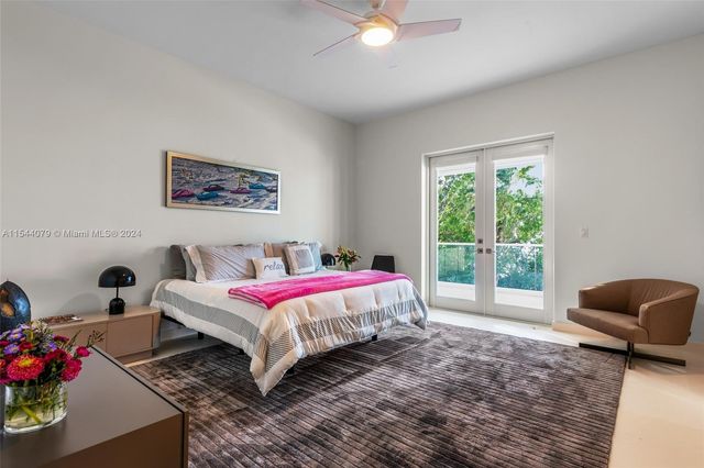 a dining room with furniture and a large window