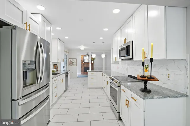 a kitchen with stainless steel appliances a refrigerator sink and microwave