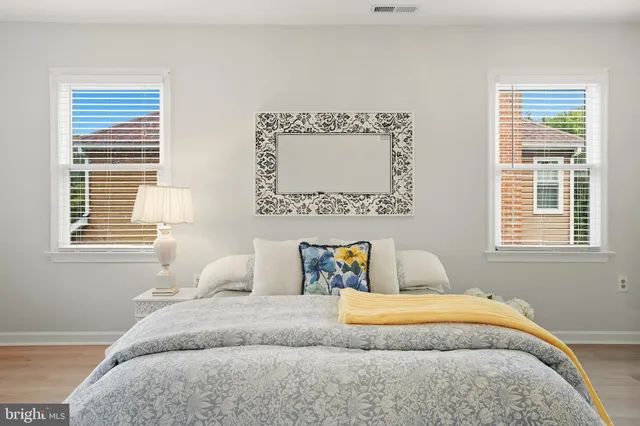 a spacious bathroom with a bathtub shower sink mirror and toilet