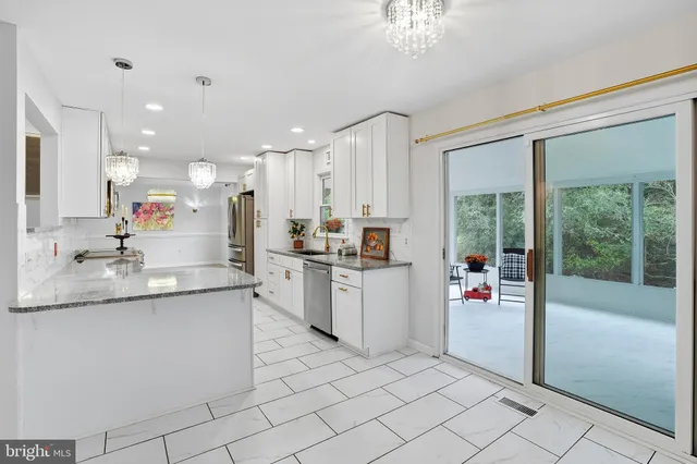 a kitchen with a sink appliances and cabinets