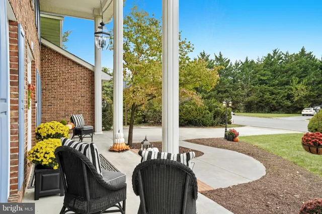 a view of balcony with two chairs and a potted plant