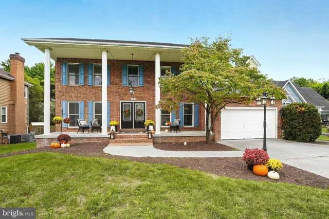 a front view of a house with swimming pool and porch