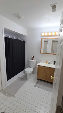 a bathroom with a sink a toilet and mirror