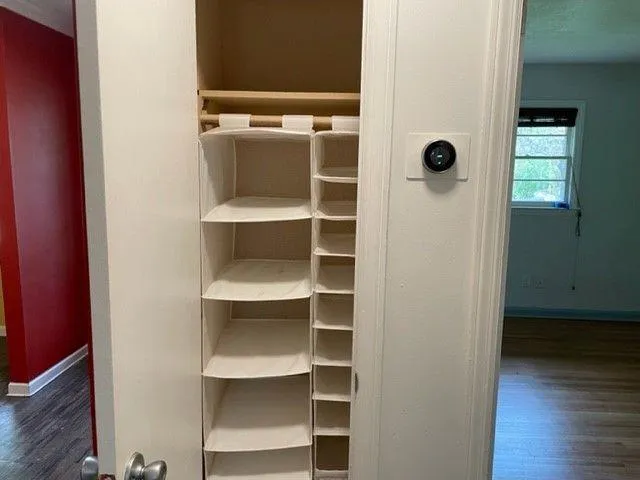 a view of walk in closet with empty racks