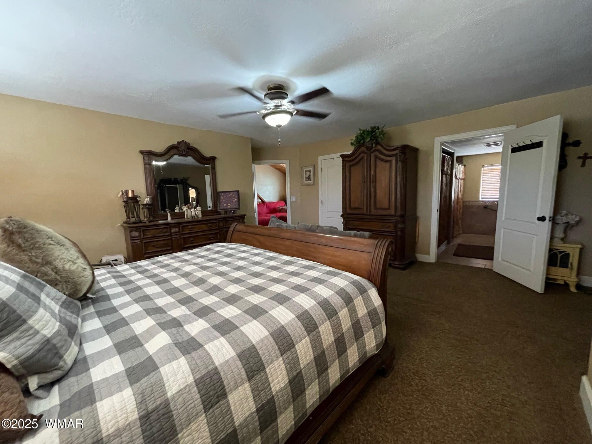 183 North Becker Lake Road Springerville, AZ 85938 - Photo 27 of 41 a bedroom with a bed dresser and a large mirror