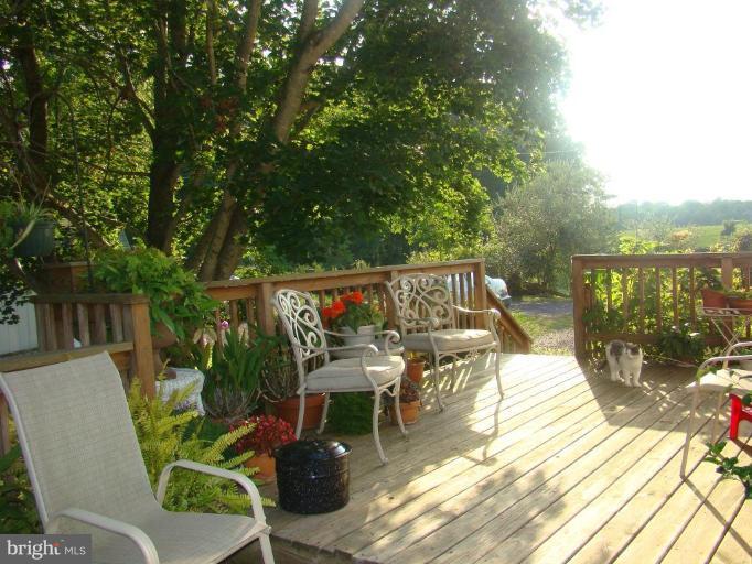 16145 Sheads Mountain Road Rixeyville, VA 22737 - Photo 18 of 20 a view of a chairs and table in patio with a lake view