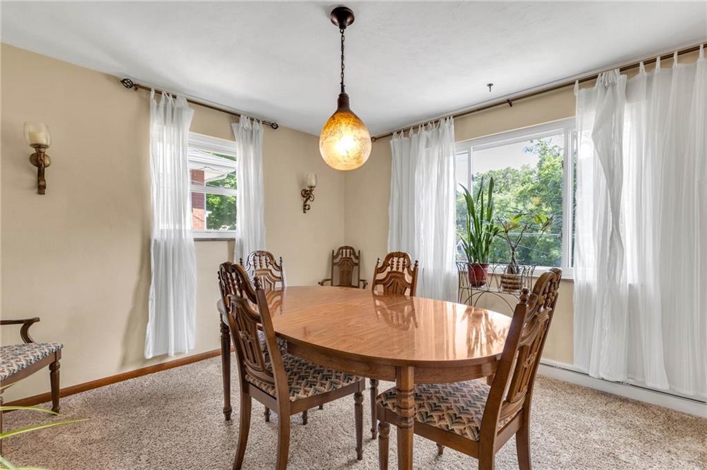 208 Gass Road Pittsburgh, PA 15229 - Photo 12 of 22 a dining room with furniture a large window and wooden floor