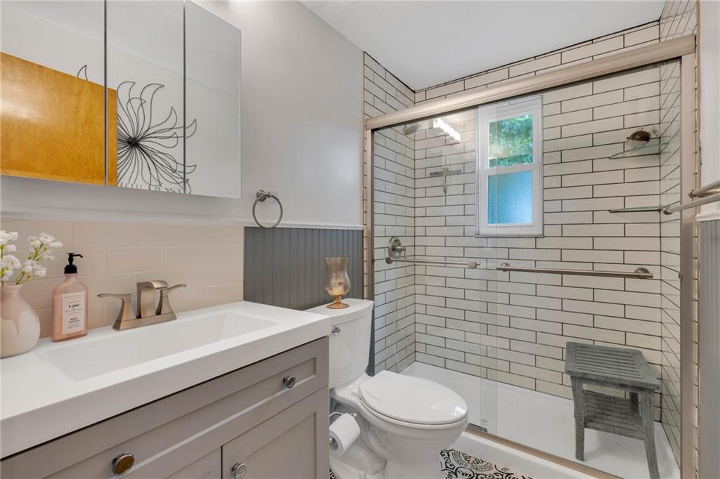 208 Gass Road Pittsburgh, PA 15229 - Photo 15 of 22 a bathroom with a sink a toilet and mirror