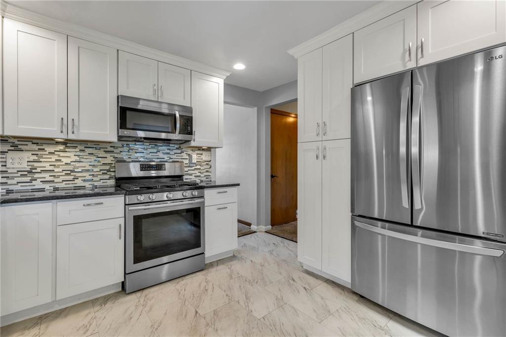 208 Gass Road Pittsburgh, PA 15229 - Photo 6 of 22 a kitchen with stainless steel appliances a refrigerator sink and microwave