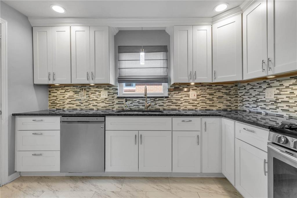208 Gass Road Pittsburgh, PA 15229 - Photo 7 of 22 a kitchen with white cabinets