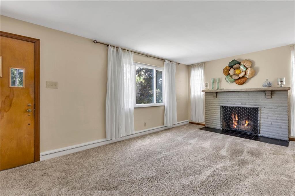 208 Gass Road Pittsburgh, PA 15229 - Photo 9 of 22 a view of an empty room with a fireplace and a window