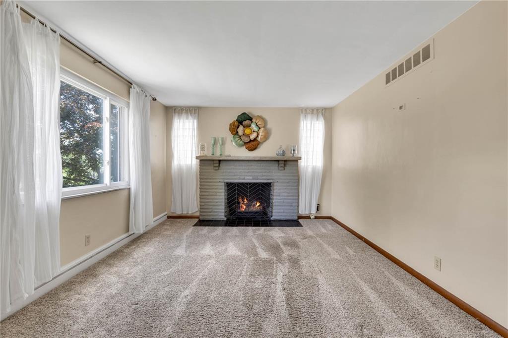 208 Gass Road Pittsburgh, PA 15229 - Photo 10 of 22 a view of an empty room with a window and fireplace