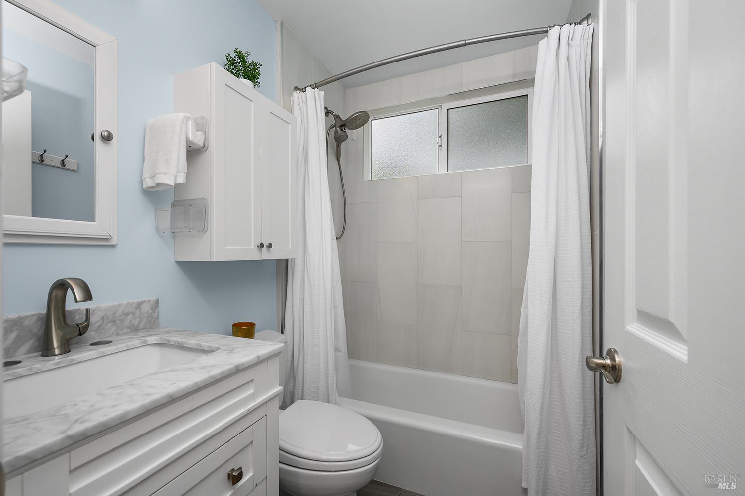 5313 Yerba Buena Road Santa Rosa, CA 95409 - Photo 19 of 34 Beautifully updated hall bathroom features modern finishes and serves the three secondary bedrooms with style and convenience.