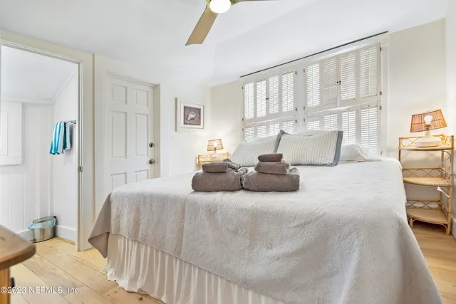 a bedroom with a bed and a night stand