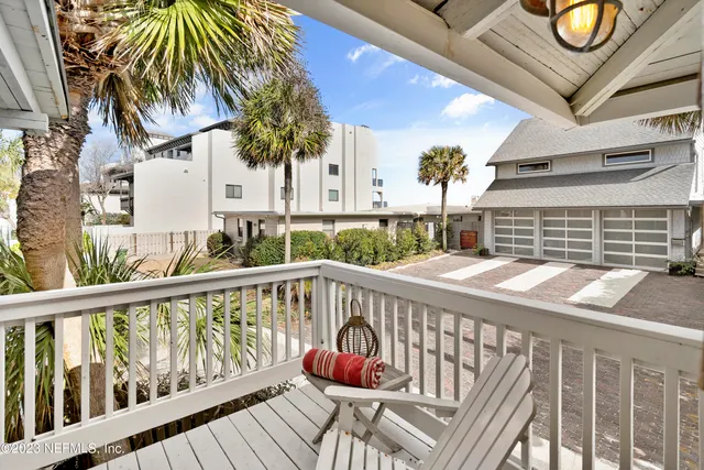 a view of balcony with a potted plant and barbeque grill