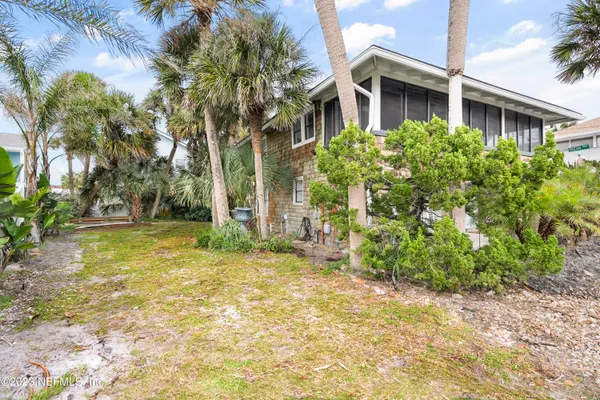 a yellow house with trees in front of it