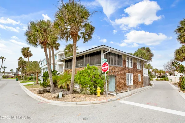 a front view of a house with yard and tree s
