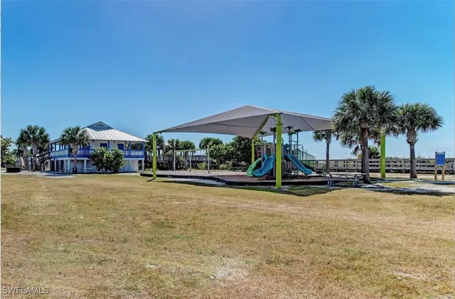 a view of a table and chairs under an umbrella