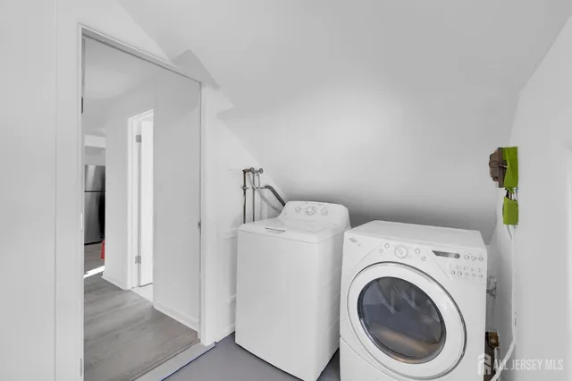 a view of storage and utility room with washer and dryer