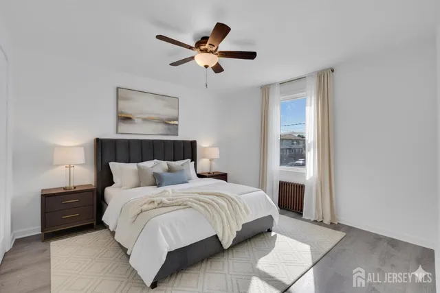 a bedroom with a bed and a painting on the wall