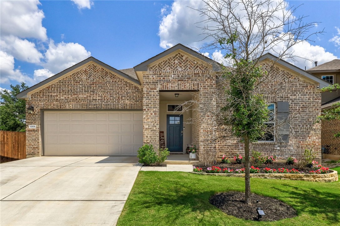 a front view of a house with a garden and plants
