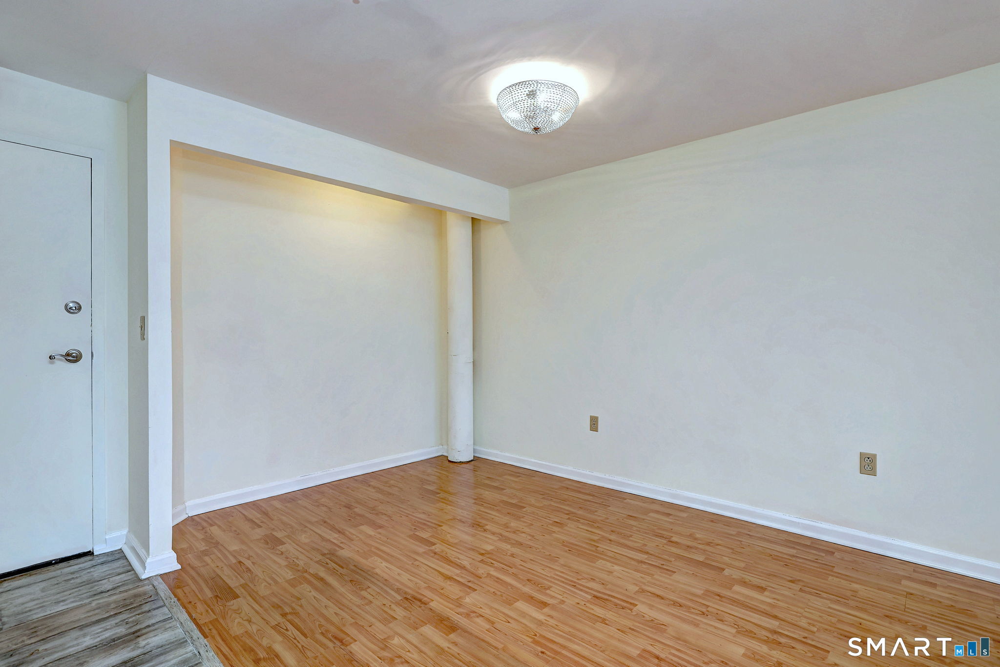 70 Putter Drive, Unit 211 Wallingford, CT 06492 - Photo 11 of 40 a view of empty room with wooden floor