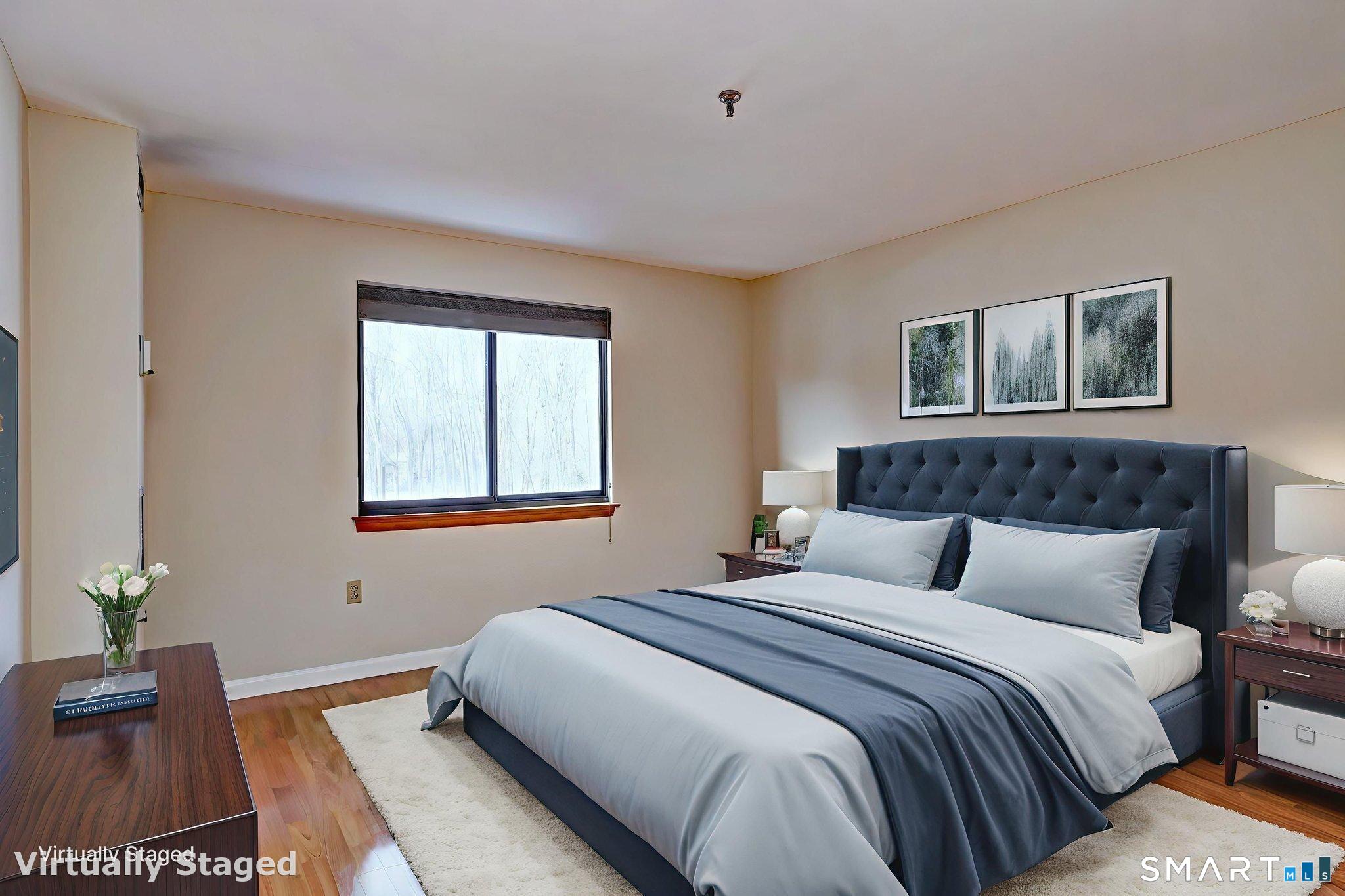 70 Putter Drive, Unit 211 Wallingford, CT 06492 - Photo 17 of 40 a bedroom with a bed and a window