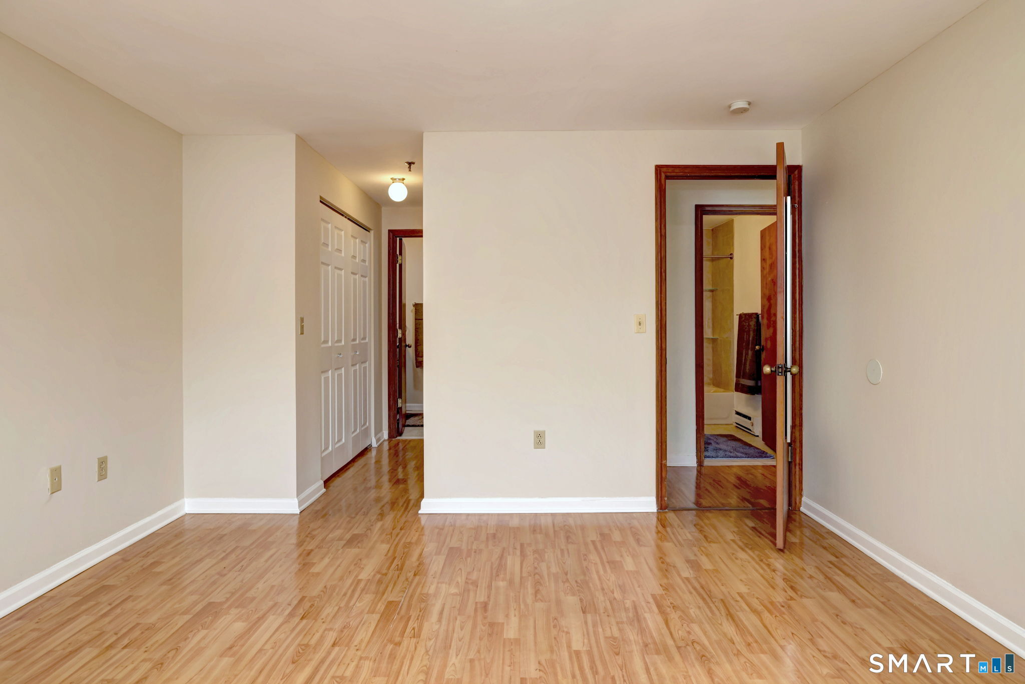 70 Putter Drive, Unit 211 Wallingford, CT 06492 - Photo 18 of 40 an empty room with wooden floor and closet