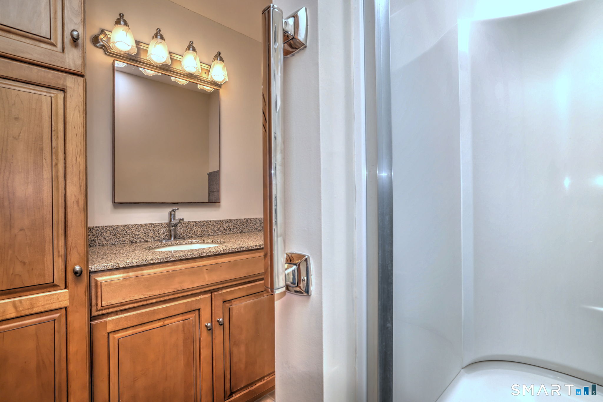 70 Putter Drive, Unit 211 Wallingford, CT 06492 - Photo 20 of 40 a bathroom with a granite countertop sink and a mirror