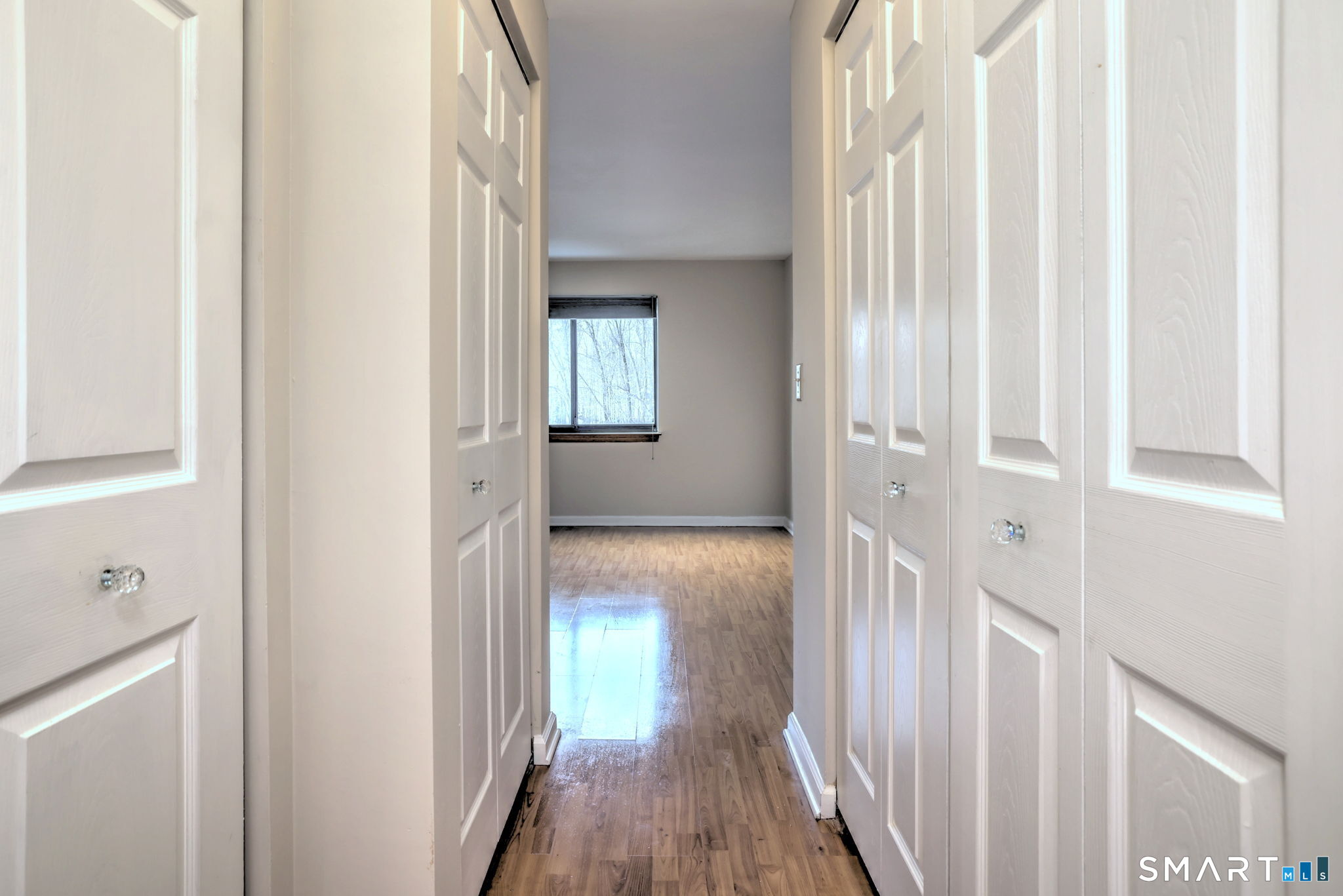 70 Putter Drive, Unit 211 Wallingford, CT 06492 - Photo 22 of 40 a view of a hallway with wooden floor and staircase