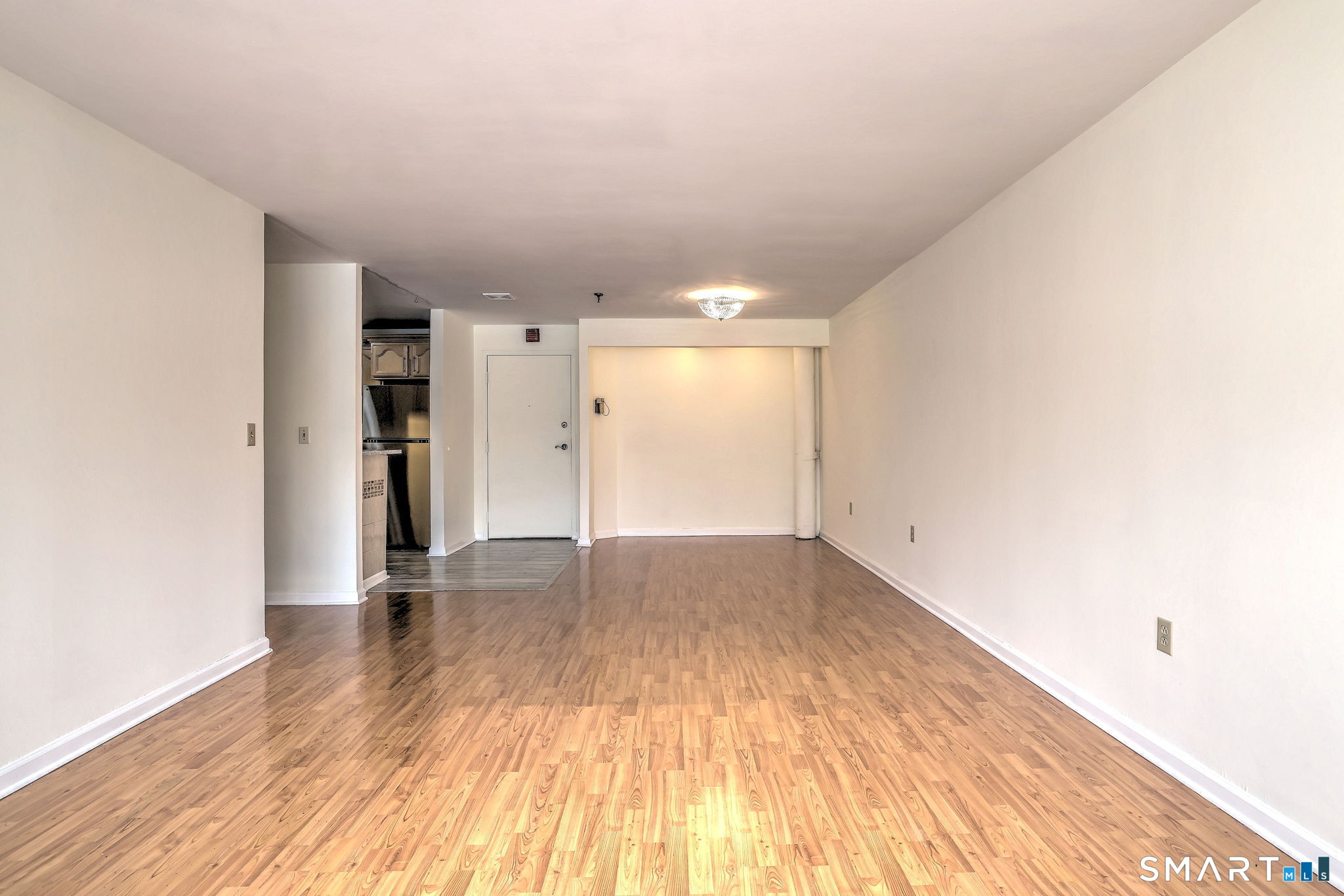 70 Putter Drive, Unit 211 Wallingford, CT 06492 - Photo 27 of 40 a view of an empty room with wooden floor