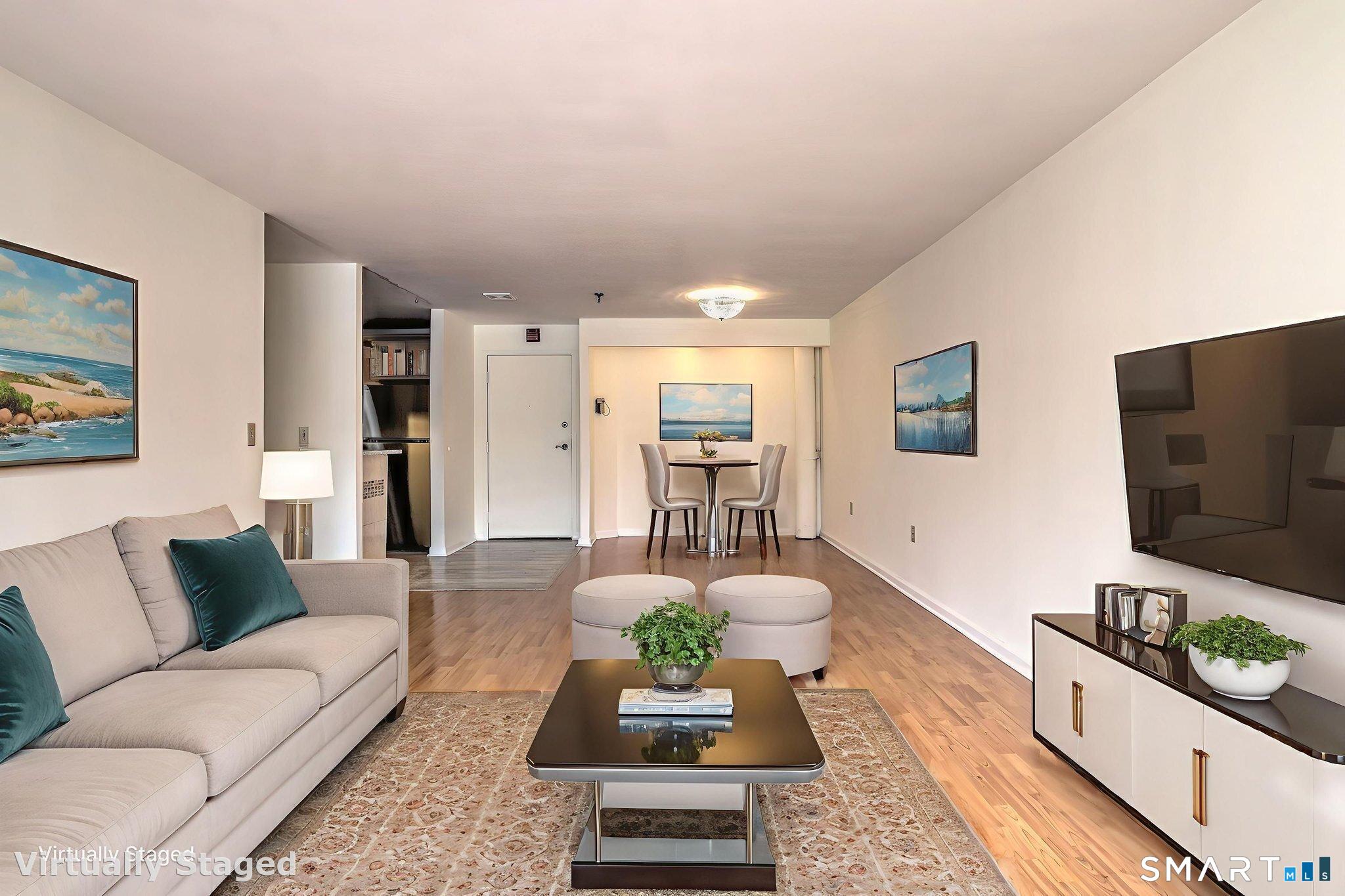 70 Putter Drive, Unit 211 Wallingford, CT 06492 - Photo 28 of 40 a living room with furniture and a flat screen tv