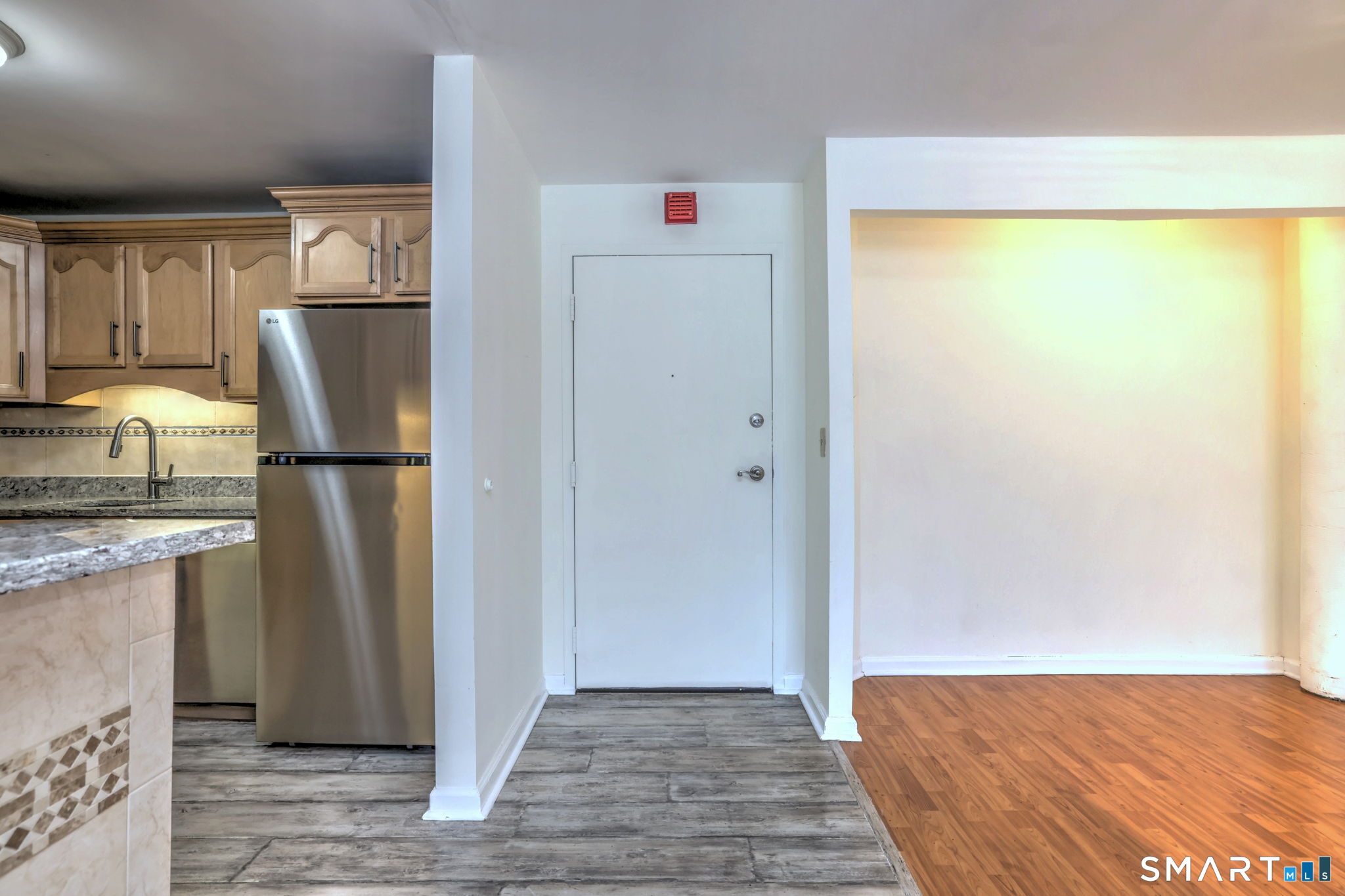 70 Putter Drive, Unit 211 Wallingford, CT 06492 - Photo 31 of 40 a view of a refrigerator in kitchen and wooden floor