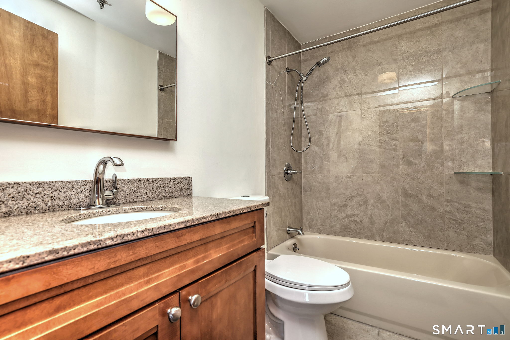 70 Putter Drive, Unit 211 Wallingford, CT 06492 - Photo 36 of 40 a bathroom with a sink a toilet and a bathtub