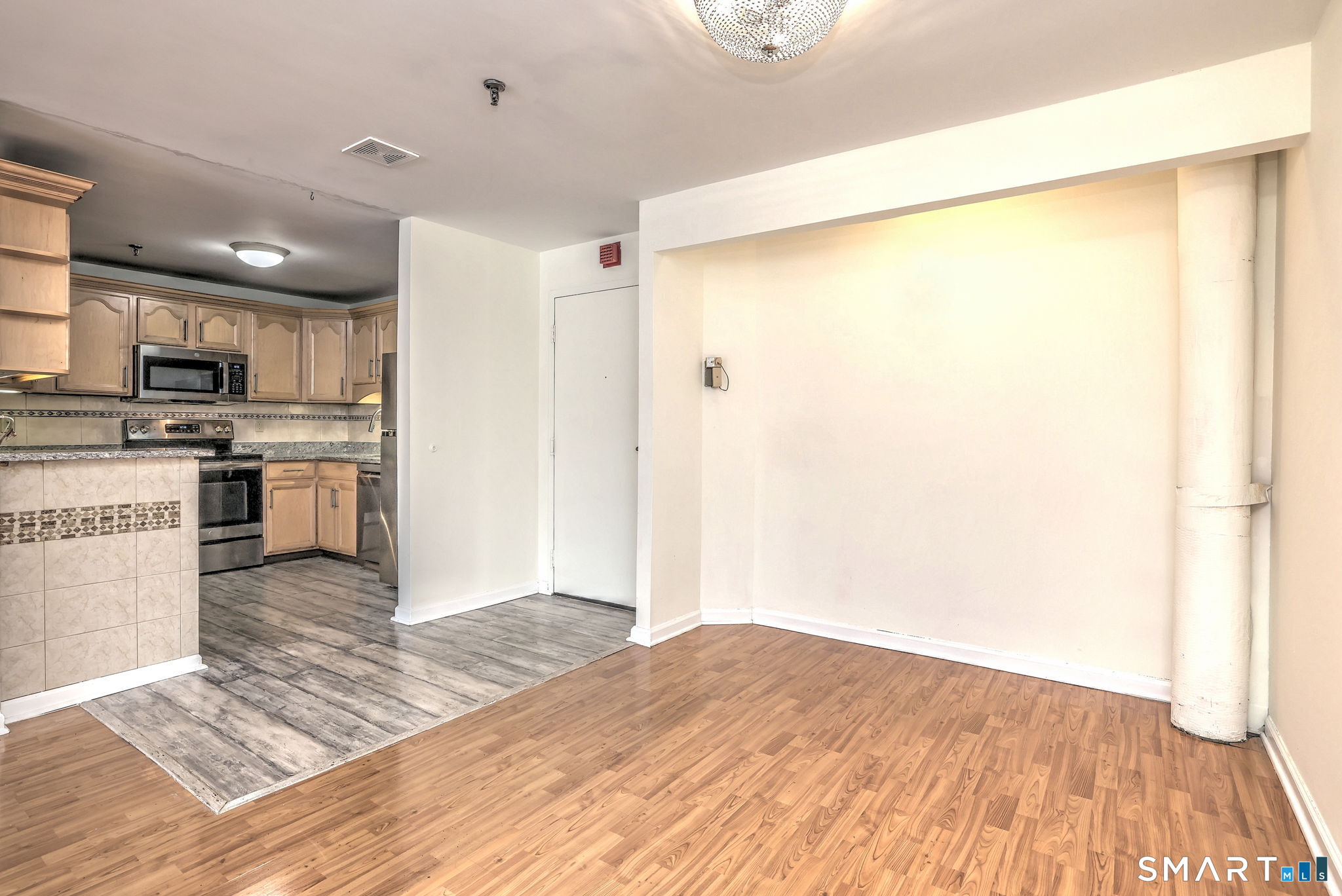 70 Putter Drive, Unit 211 Wallingford, CT 06492 - Photo 8 of 40 a kitchen with a refrigerator and a stove top oven