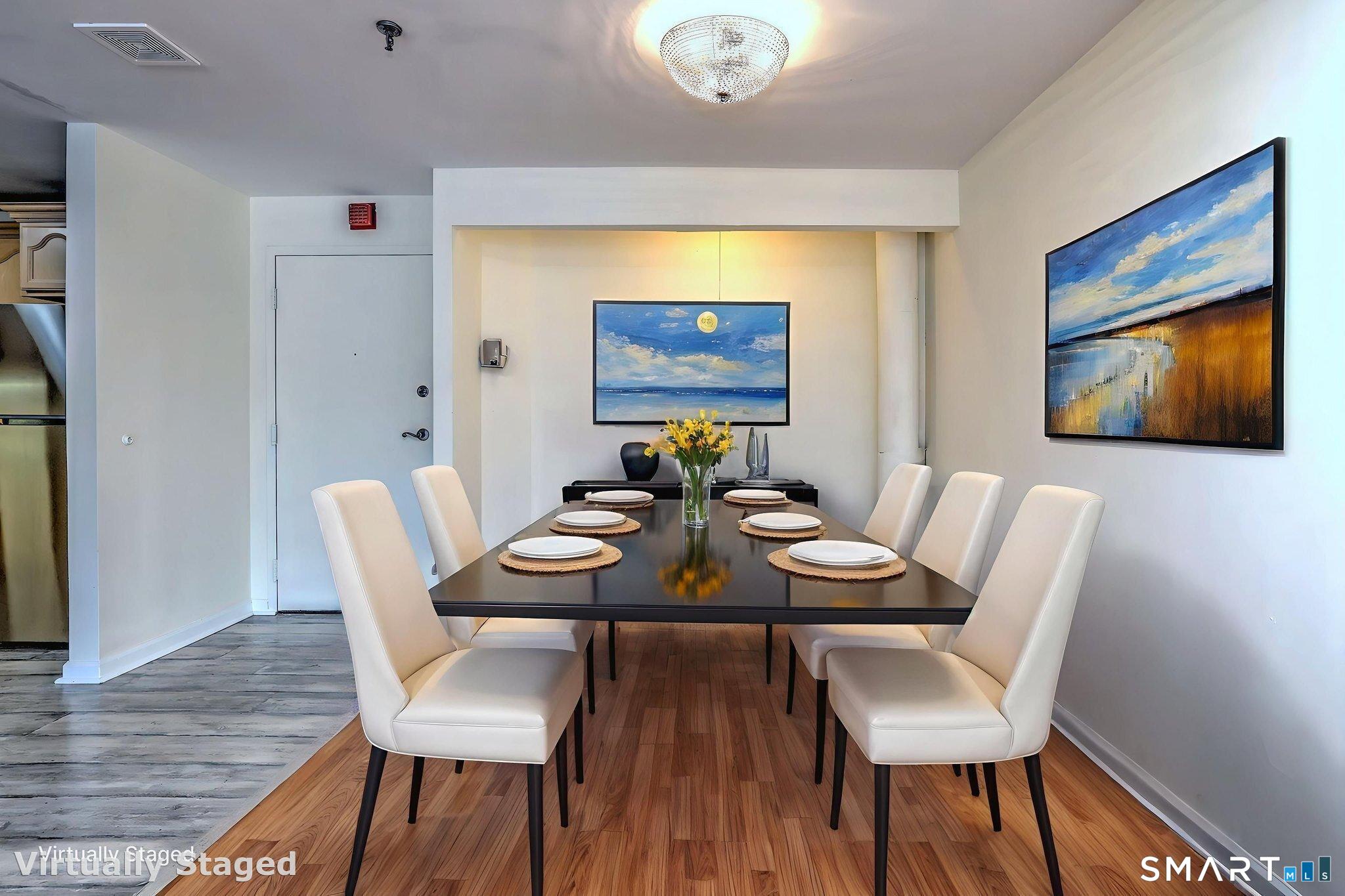 70 Putter Drive, Unit 211 Wallingford, CT 06492 - Photo 10 of 40 a view of a dining room with furniture and wooden floor