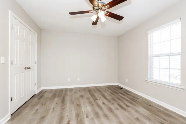 wooden floor in an empty room with a window