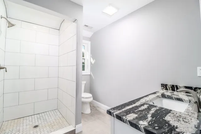 a bathroom with a sink toilet and shower