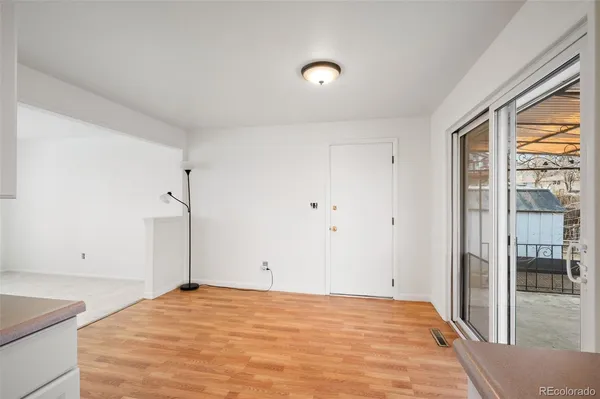 a view of empty room with wooden floor