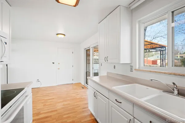 a kitchen with a sink and large window