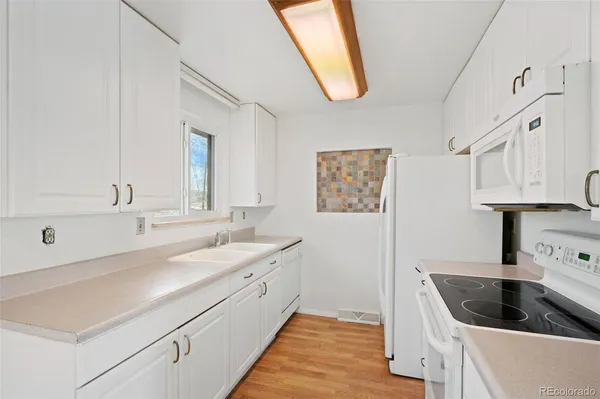 a kitchen with a sink stove and cabinets