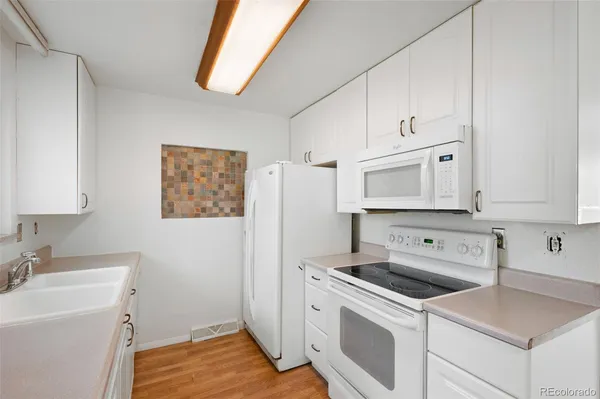 a view of a kitchen with sink washer and dryer