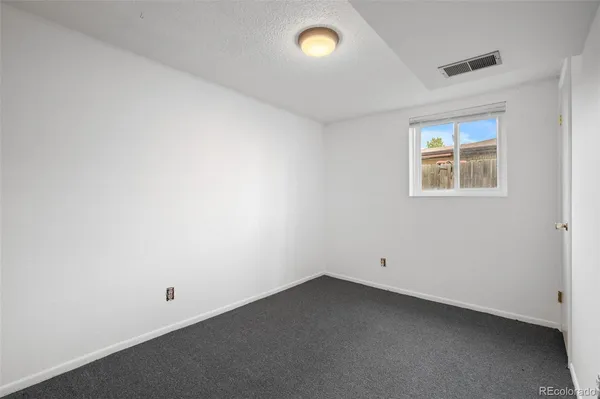 an empty room with a empty space and a window