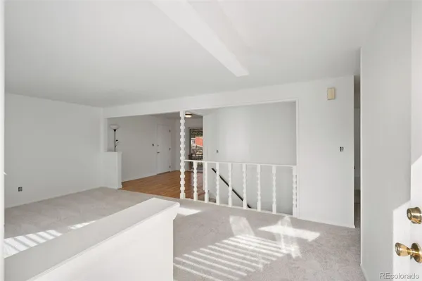 a view of a room with wooden floor and staircase