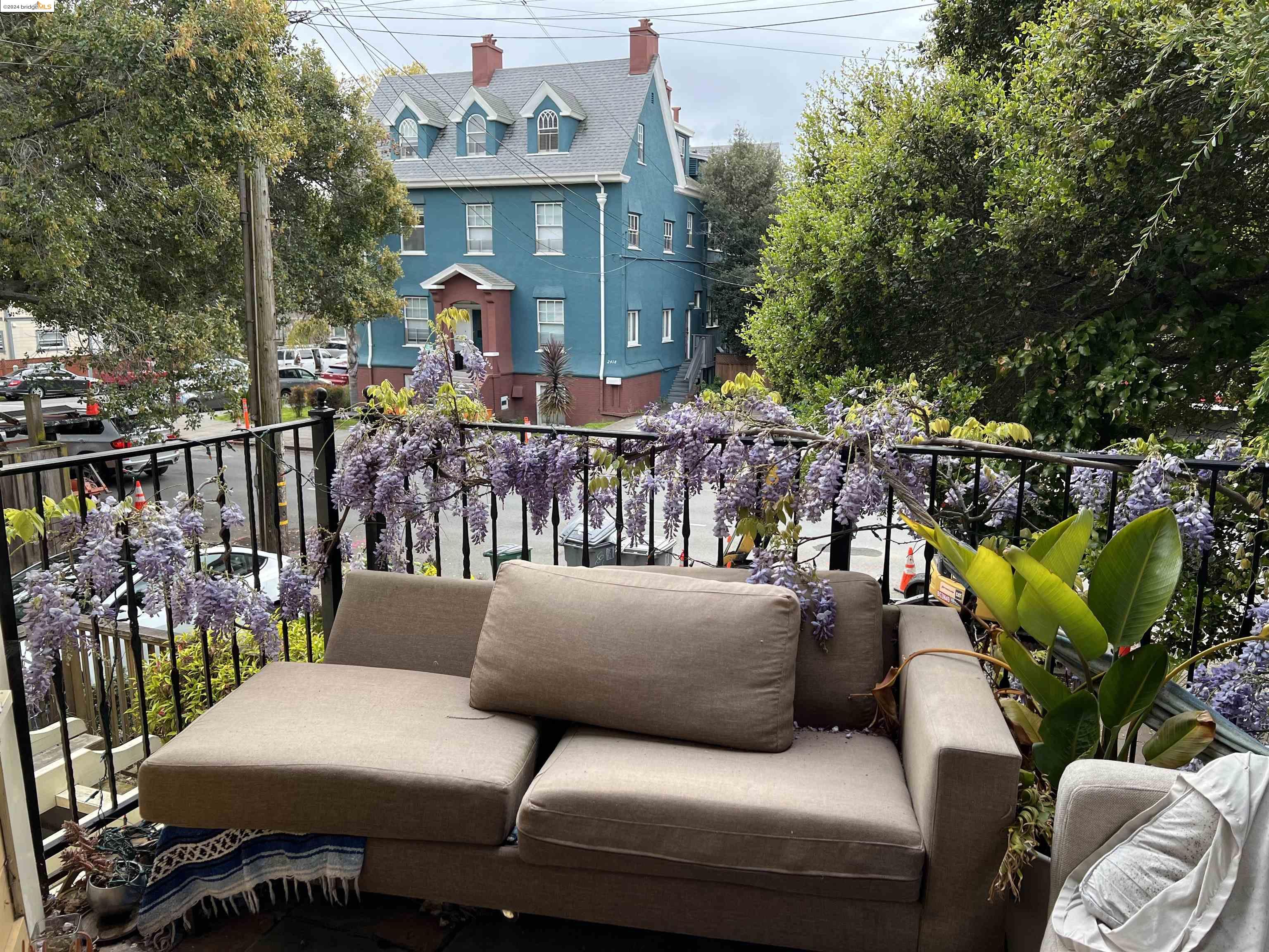 a view of a patio with couches table and chairs and potted plants