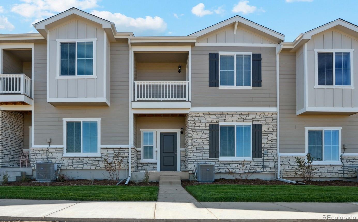 921 Montbello Avenue Fort Lupton, CO 80621 - Photo 1 of 40 a front view of a house with garden